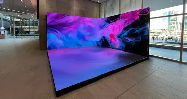 Immersive corner LED wall installation glowing in a modern lobby
