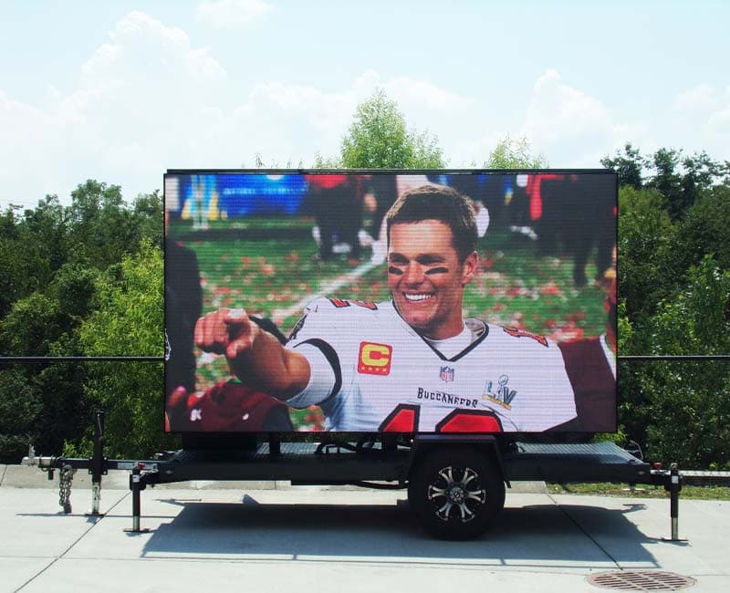 Mobile LED trailer displaying live sports content outdoors